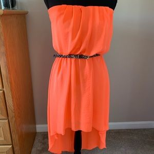 Coral colored, strapless dress.